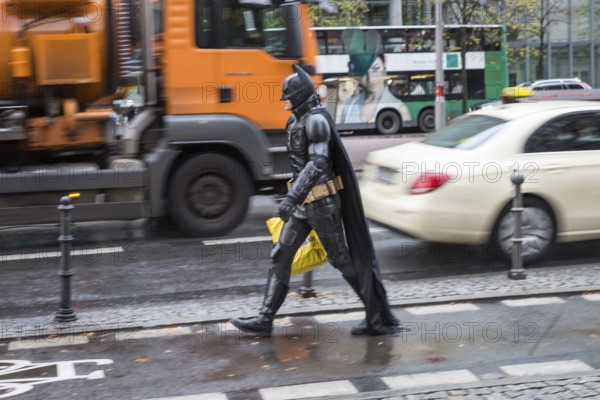 DEU Germany Germany Berlin A man wearing a Batman costume walks across Potsdamer Platz
