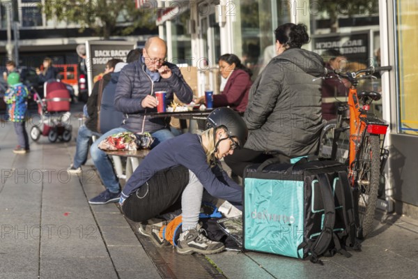DEU Germany Germany Berlin A bicycle courier packs his transport container with an order from a fast food restaurant in front of the European Centre
