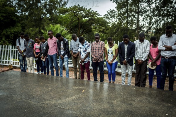 RWA RWANDA RUANDA Kigali A youth group stands in front of a mass grave at the genocide memorial site