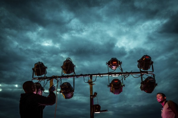 RWA RWANDA RUANDA Kigali Installation of floodlights on the terrace of Panorama Bar Ivy against the cloudy sky