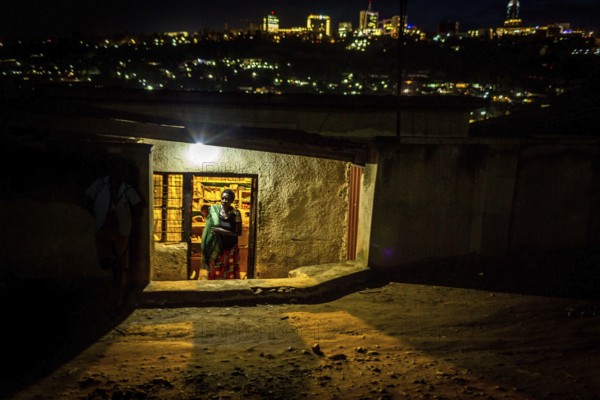 RWA RWANDA RUANDA Kigali Illuminated houses in a poor neighbourhood. The Kiyovu banking district in the background