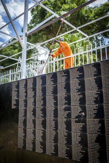 RWA RWANDA RUANDA Kigali Working at the memorial in front of a list of names in preparation for the commemoration of the anniversary of the genocide