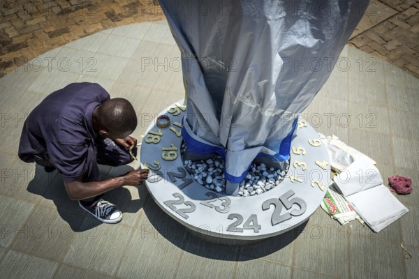 RWA RWANDA RUANDA Kigali An assistant completing the flame in preparation for the genocide anniversary celebrations The flame installation will burn for 100 days from 7 April