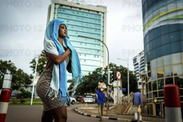 RWA RWANDA RUANDA Kigali A woman with scarves around her head walks in the banking district of Kiyovu