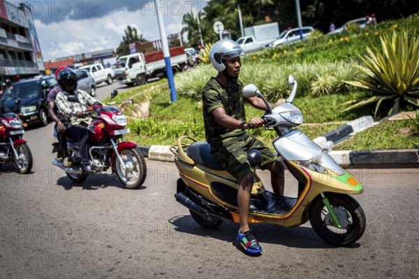 RWA RWANDA RUANDA Kigali A youth in camouflage fashion on a scooter