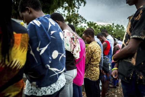 RWA RWANDA RUANDA Kigali A youth group stands in front of a mass grave at the genocide memorial site