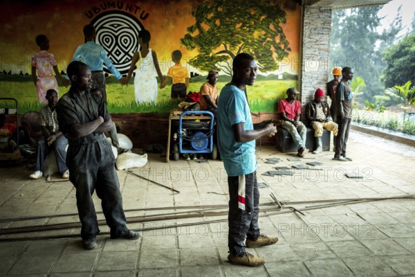 RWA RWANDA RUANDA Kigali workers take a break due to rain showers. They are renovating the amphitheatre in preparation for the genocide anniversary celebrations at the genocide memorial site