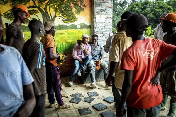 RWA RWANDA RUANDA Kigali workers take a break due to rain showers. They are renovating the amphitheatre in preparation for the genocide anniversary celebrations at the genocide memorial site