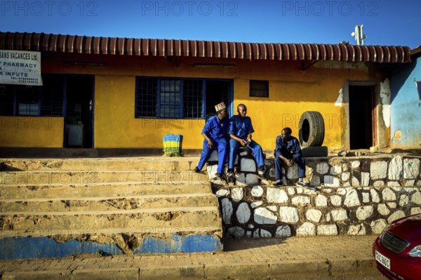 RWA RWANDA RUANDA Kigali Tyre mechanics wait for customers in front of their workshop