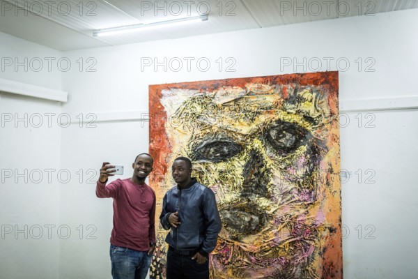 RWA RWANDA RUANDA Kigali Guests take a selfie at a regular party at the Inema Gallery. Artists, locals and expats meet here every Thursday