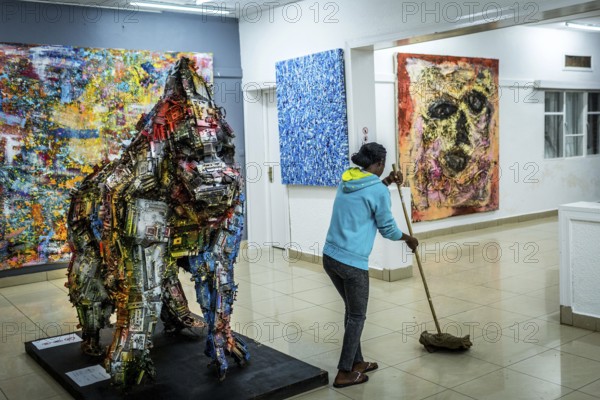RWA RWANDA RUANDA Kigali A cleaning lady mops during the party at the Inema Gallery. Artists, locals and expats meet here every Thursday