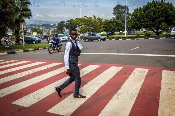 RWA RWANDA RUANDA Kigali A pedestrian in a suit crosses a zebra crossing in the banking district of Kiyuvo