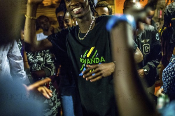 RWA RWANDA RUANDA Kigali Guests at a regular party organised by the Inema Gallery. Artists, locals and expats meet here every Thursday
