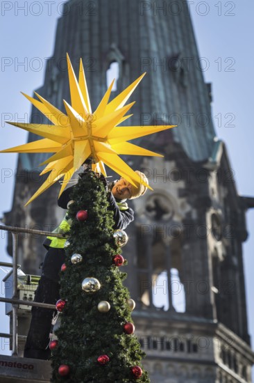DEU Germany Germany Berlin Setting up the Christmas market at Breitscheidtplatz. The memorial church in the background