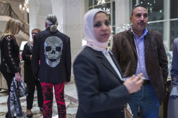 Egypt Hurghada Guests wait in a hotel lobby for the start of an event. One guest is wearing a jacket with a skull and crossbones