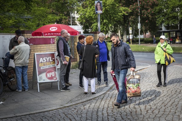 DEU Germany Germany Berlin Open day for the presentation of a new anchor centre on the grounds of the Karl Bonhoeffer mental hospital in Reinickendorf Migrants pass an NPD stand