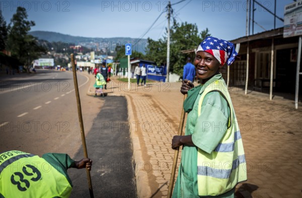 RWA RWANDA RUANDA Kigali Street cleaners clean a road leading to the Genocide Memorial on the morning in front of the commemoration of the genocide of Rwandan Tutsis 25 years ago