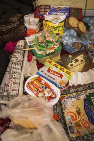 DEU Germany Germany Berlin Homeless people spend the night in a passage at Lichtenberg underground station. Like Moritzplatz, the station has been made available by the BVG for overnight stays during the winter months, with a homeless man's food lying next to his sleeping bag