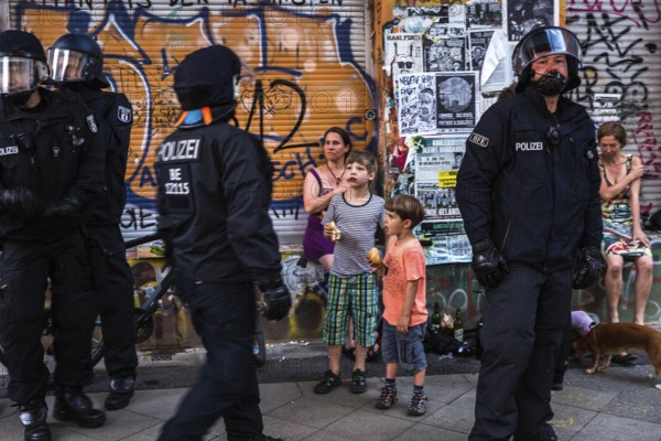 DEU Germany Germany Berlin Scene from Rigaer Straße, where squatters protest against the further gentrification of their neighbourhood. Riot police on duty during a party in a squat, confiscating chairs that guests had been sitting on in the street