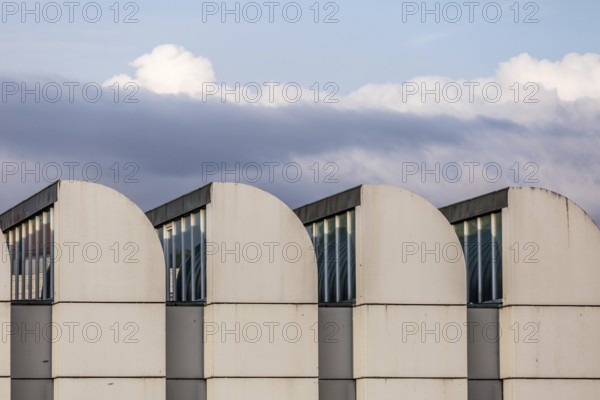 DEU Germany Germany Berlin The towers of the Bauhaus Museum are lined up against a cloudy sky. The archive is currently being renovated and remodelled