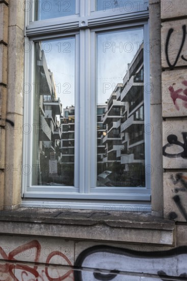 DEU Germany Germany Berlin Scene from Rigaer Strasse, where squatters protest against the further gentrification of their living space.new building complex between Rigaer- and Liebigstrasse is reflected in an old building window