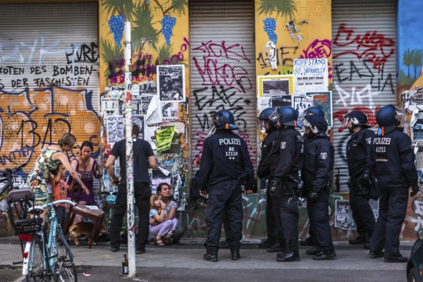 DEU Germany Germany Berlin Scene from Rigaer Straße, where squatters protest against the further gentrification of their neighbourhood. Riot police on duty during a party in a squat, confiscating chairs that guests had been sitting on in the street