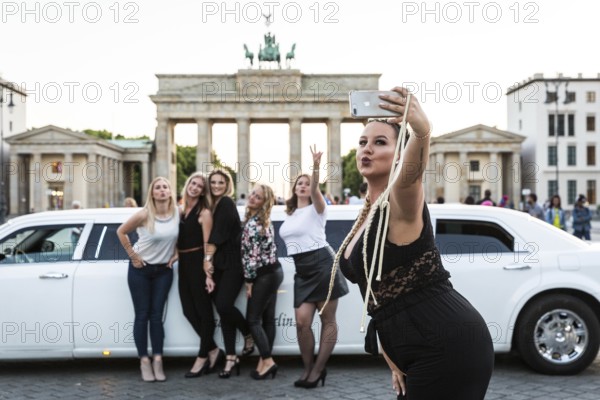 DEU Germany Germany Berlin Young woman pose with a rented stretch limousine in front of the Brandenburg Tor