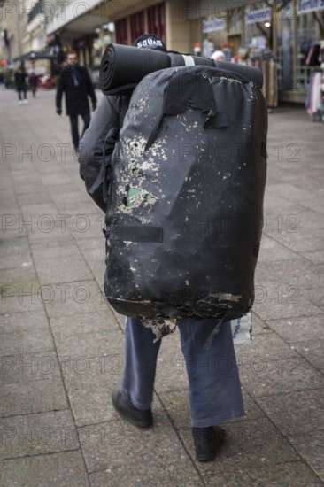 DEU Germany Germany Berlin A homeless man carries a huge bag with his belongings through the city