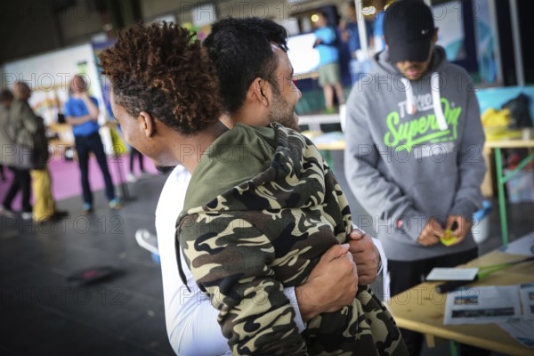 DEU Germany Germany Berlin As part of the German Foundation Week, the Cologne-based organisation Rheinflanke demonstrates sports facilities for refugees in the hangar at Tempelhof Airport. Two refugee friends greet each other