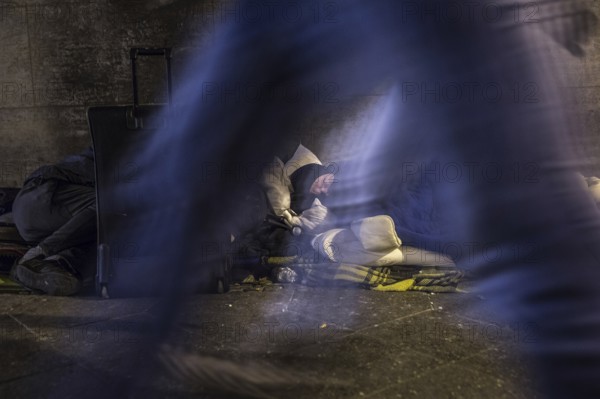 DEU Germany Germany Berlin Scenes of homeless people around Bahnhof Zoo, passers-by walk past a bed camp under a bridge