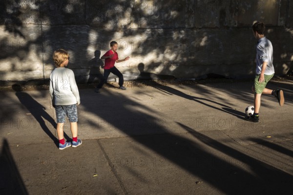 DEU Germany Germany Berlin Children play football while their parents watch a World Cup match in the Prater beer garden