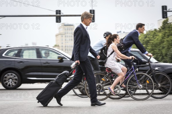DEU Germany Germany Berlin Scene with cyclists in traffic in the capital Karl-Marx-Alle, corner of Otto-Braun-Str