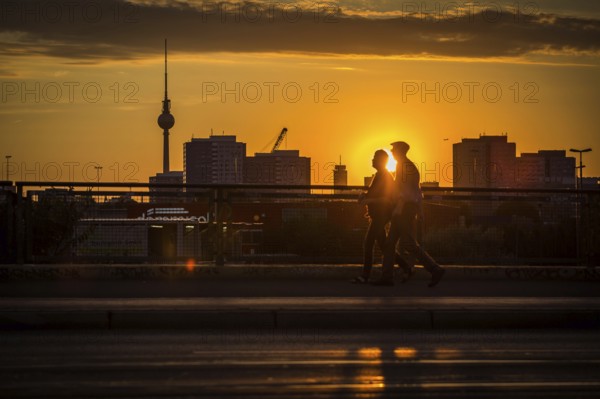 DEU Germany Germany Berlin Cyclists and pedestrians at sunset on the Warsaw Bridge