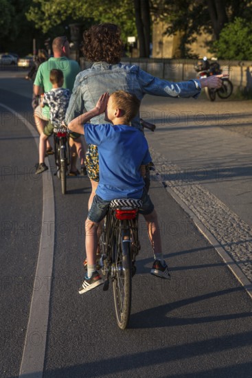 DEU Germany Germany Berlin Parents with their children on the pannier rack during a bike tour through Berlin