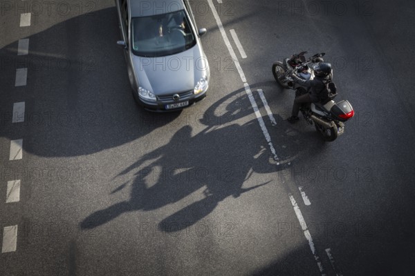 DEU Germany Germany Berlin Scene with motorcyclist on Schlossstraße in Steglitz Motorcyclist turns off