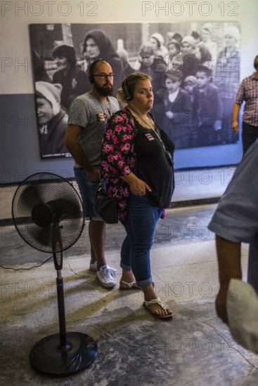 POL Poland Poland Auschwitz Visitors view photos of the Holocaust at the memorial site of the former Auschwitz concentration camp