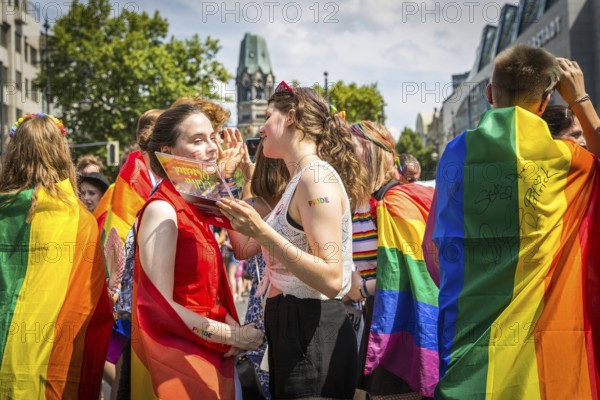 DEU Germany Germany Berlin Scenes from Christopher Street Day CSD on a hot Saturday . Young people touching up their make-up