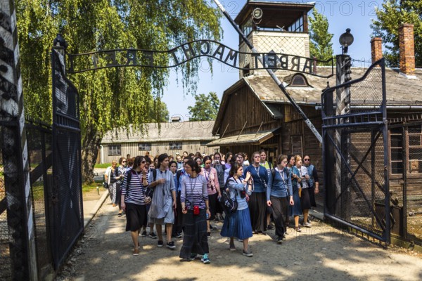 POL Poland Poland Auschwitz group of visitors at the entrance to the memorial site of the former Auschwitz concentration camp