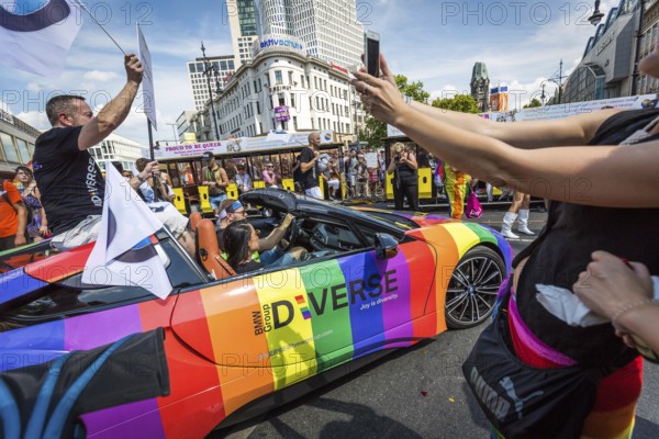 DEU Germany Germany Berlin Scenes of the Christopher Street Day CSD on a hot Saturday . BMW sports car in rainbow look