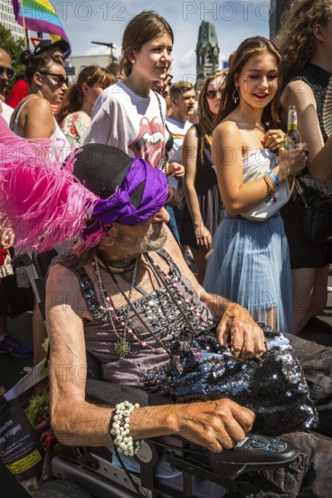 DEU Germany Germany Berlin Scenes of the Christopher Street Day CSD on a hot Saturday . Young woman look at a participant in a wheelchair