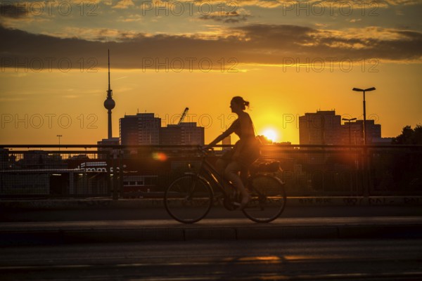 DEU Germany Germany Berlin Cyclists and pedestrians at sunset on the Warsaw Bridge