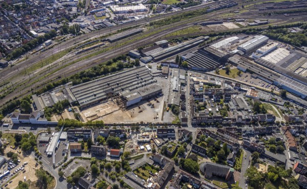 Aerial view, construction site on the WDI site between Bahndamm and Otto-Brenner-Straße, new district centre Wilhelmstraße, Hamm, Ruhr area, North Rhine-Westphalia, Germany, DE, Europe, birds-eyes, view, aerial photograph, aerial photography, aerial photography, overview, overview, bird's eye view, railway line, railway network, infrastructure, transport, train traffic, freight traffic, railway network, metal processing, metal processing, industry, production, workplaces