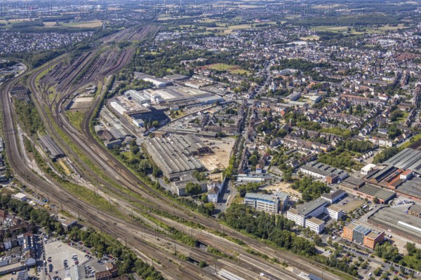 Aerial view, construction site on the WDI site between Bahndamm and Otto-Brenner-Straße, new district centre Wilhelmstraße, Hamm, Ruhr area, North Rhine-Westphalia, Germany, DE, Europe, birds-eyes, view, aerial photograph, aerial photography, aerial photography, overview, overview, bird's eye view, railway line, railway network, infrastructure, transport, train traffic, freight traffic, railway network, metal processing, metal processing, industry, production, workplaces