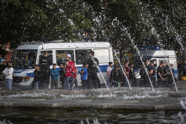 DEU Germany Germany Berlin Police officers guarding a group of young Mirgants at Alexanderplatz