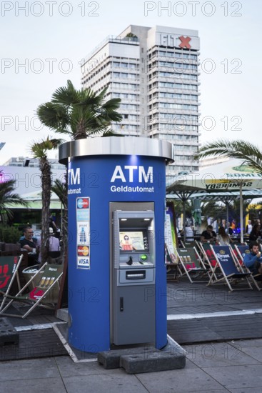 DEU Germany Germany Berlin An EC machine in front of a bar on Alexanderplatz