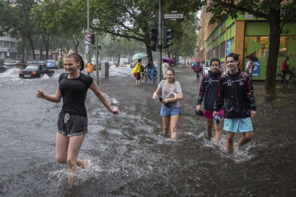 DEU Germany Germany Berlin Scene of the storm in Berlin. Young people cross the flooded Trauenaustrasse