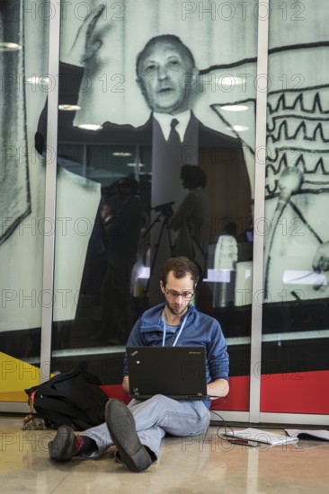 DEU Germany Germany Berlin A journalist sits on the floor during the presentation of the CDU/CSU election programme in the Konrad Adenauer House