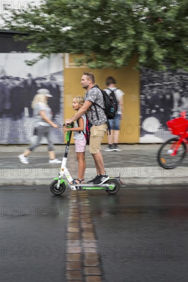 DEU Germany Germany Berlin Tourists with e-scooters at Checkpoint Charlie