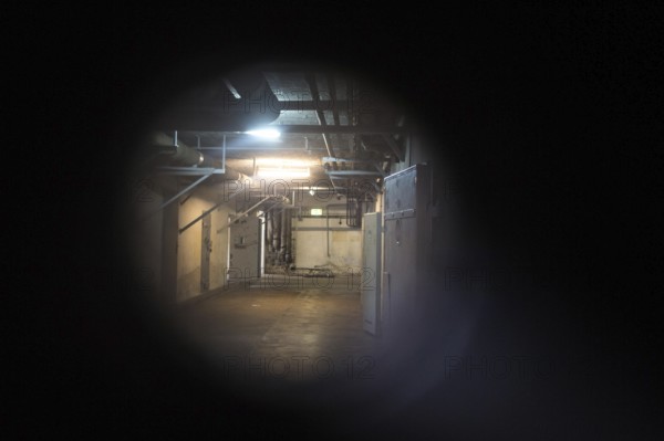 DEU Germany Germany Berlin Open day at the Hohenschönhausen Memorial, the former State Security prison. View through a peephole into a corridor of the Ubott, a cellar for solitary confinement