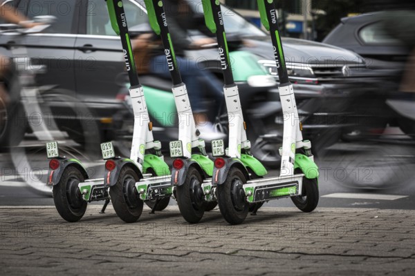 DEU Germany Germany Berlin Traffic passes parked e-scooters on Karl-Liebknecht-Str